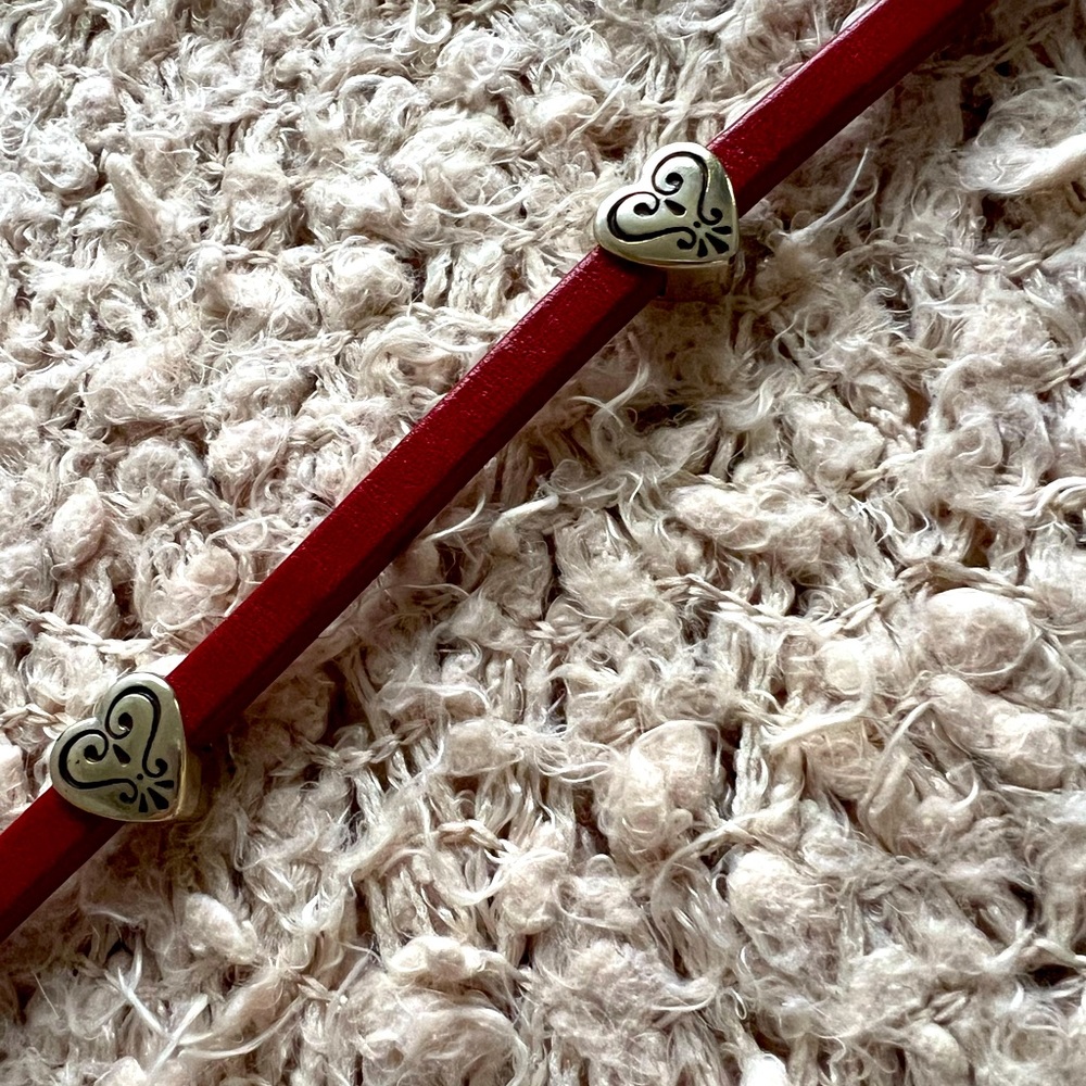 Brighton red belt with hearts and chain.
